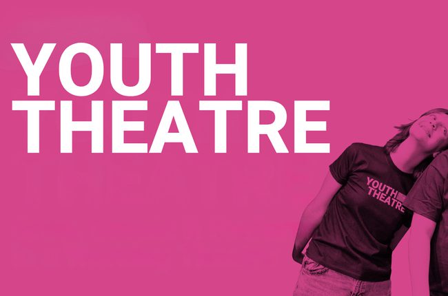 Bright pink background, white text in left corner reads "Youth Theatre" with a photo of children on the right smiling and posed in Chipping Norton Theatre Youth Theatre tshirts
