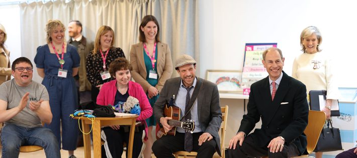 HRH The Duke of Edinburgh sits smiling with our Great Company members