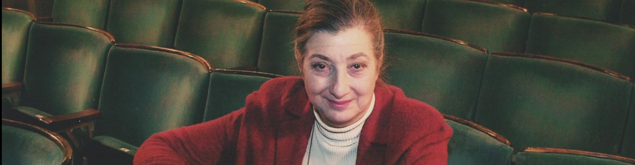 Tamara Malcom sits in the theatre auditorium