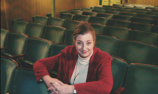 Tamara Malcom sits in the theatre auditorium