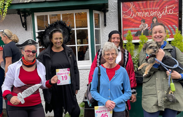 Runners in different costumes including a witch and a pirate