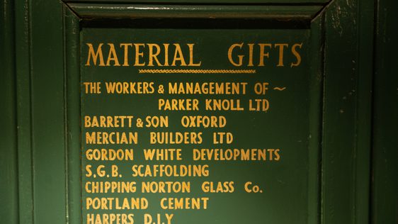 Green board with gold writing listing the material gifts in kind donated when the Theatre was built