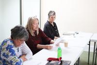 Three Creative Writers going over their work
