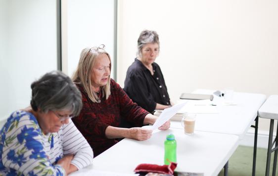 Three Creative Writers going over their work