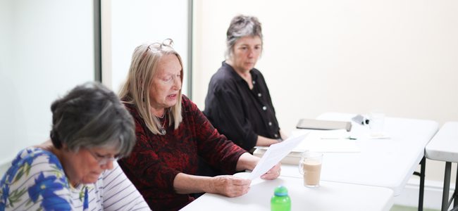 Three Creative Writers going over their work