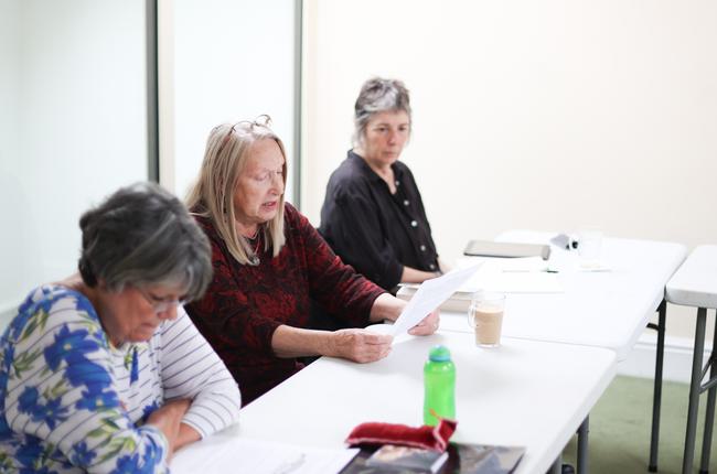 Three Creative Writers going over their work