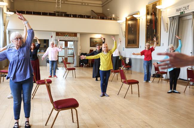 Group dancing with arms held in 4th position