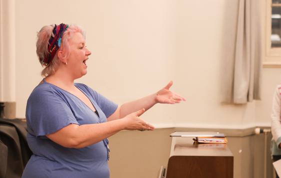 Choir leader conducting singers