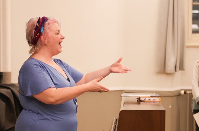 Choir leader conducting singers