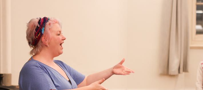 Choir leader conducting singers