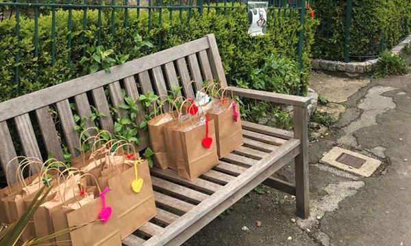 Free School Meal lunch bags on a bench outside theatre
