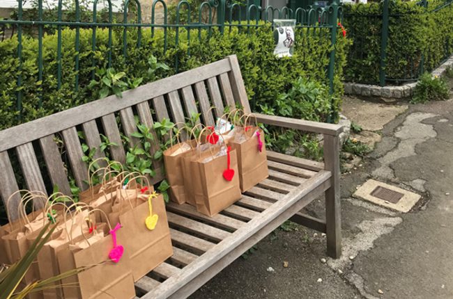 Free School Meal lunch bags on a bench outside theatre