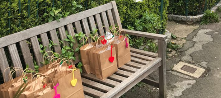 Free School Meal lunch bags on a bench outside theatre
