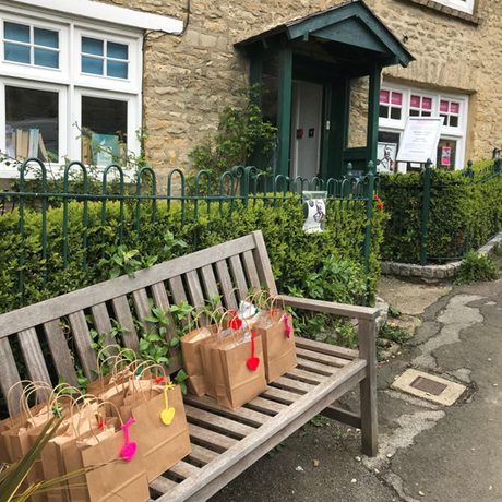 Free School Meal lunch bags on a bench outside theatre