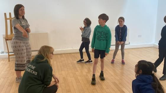 Group playing a drama game as part of a workshop