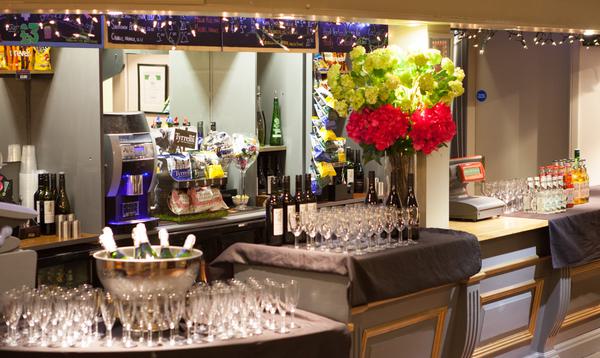 Champagne bucket and flutes waiting on the edge of grey Theatre bar