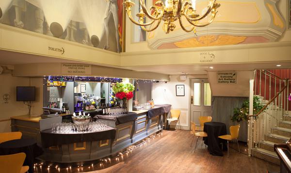 The Theatre bar area showing gold chandelier and murals