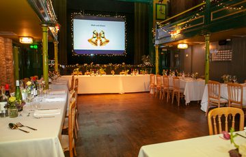 Auditorium set-up for a wedding with long tables in U-shape