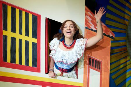 Cinderella waving from her house in the Christmas pantomime 2023