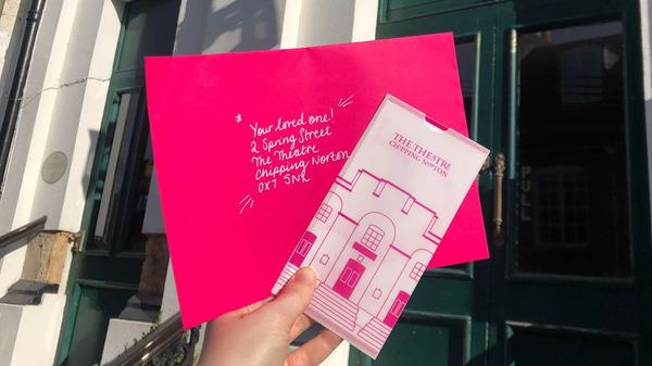 Theatre gift voucher and pink envelope